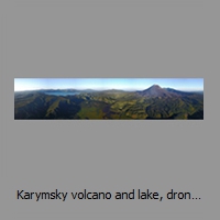 Karymsky volcano and lake, drone panorama